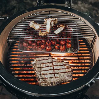 Abundantly loaded open Monolith grill with various foods