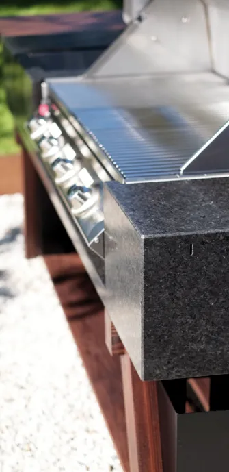 Close-up of an OCQ outdoor kitchen with dark gray granite elements